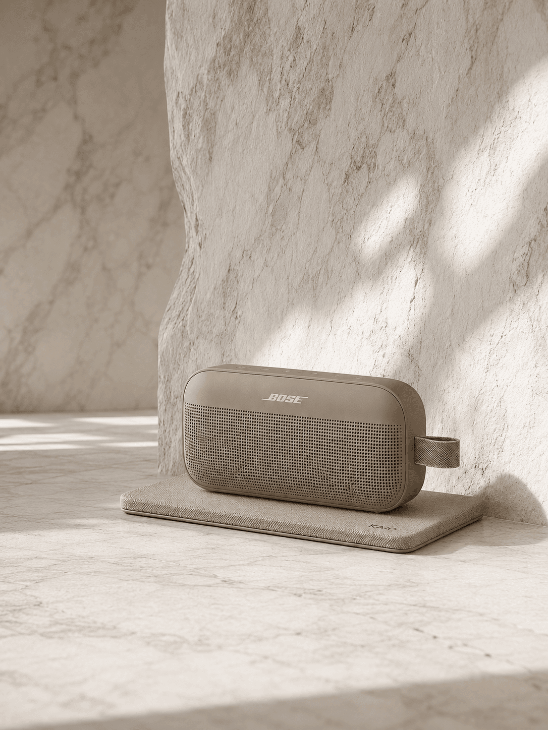 Bose portable speaker on a rectangular KAIO Speaker Pad