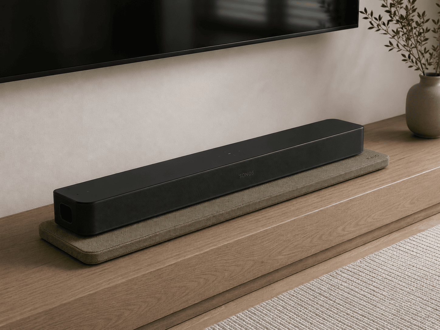 Soundbar resting on KAIO Speaker Pad on a warm modern console